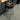 A black bar stool with a humminbird logo, set inside a workshop.